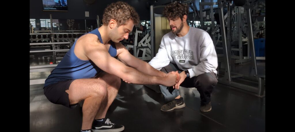 Max Dennehy Dietitian teaching Matthew Rigoni Dietitian (APD) how to squat with correct form for optimal hypetrophy and muscle growth without pain Max Dennehy Dietitian teaching Matthew Rigoni Dietitian (APD) how to squat with correct form for optimal hypetrophy and muscle growth without pain