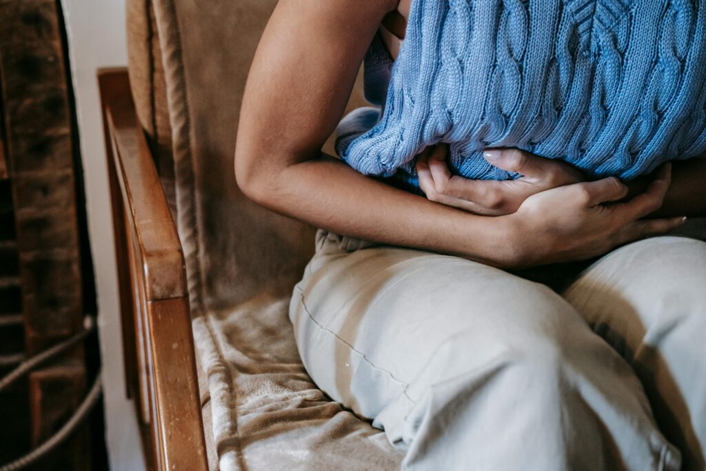 pexels-photo-5938358-5938358 Female with stomach pain Diverticulitis holding stomach tummy, belly, bowels
